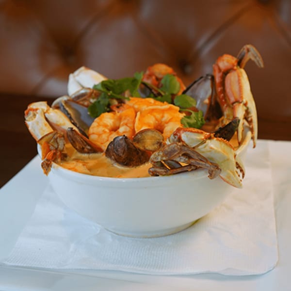 A large bowl of Lempira Restaurant's Latin-American seafood soup with crab, shrimp, and mussels.